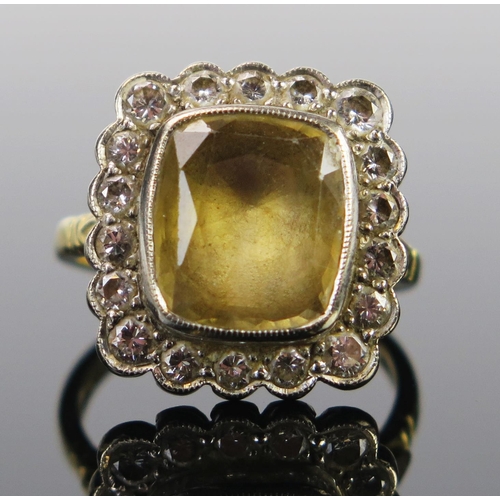 82 - An 18ct Gold,  Yellow and Diamond Cluster Ring, the c. 12x11mm stone in a millegrain setting, London... 