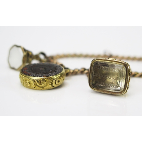 88 - A Yellow Metal Curb Link Bracelet with two seals, one with crystal matrix engraved 'Présent néanmoin... 