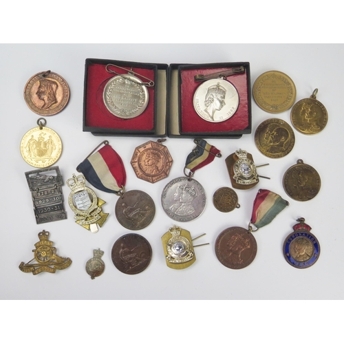 912 - A collection of Royal commemorative medallions, Empire Day medallions, three stay-brite army badges ... 