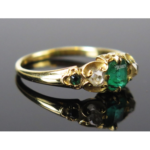 92 - An Emerald and Diamond Five Stone Ring in an unmarked high carat gold setting, the central emerald a... 