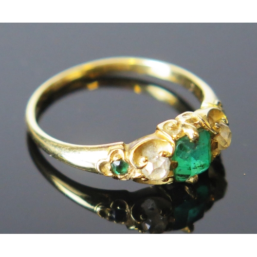 92 - An Emerald and Diamond Five Stone Ring in an unmarked high carat gold setting, the central emerald a... 