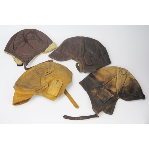 935A - Four various brown leather flying helmets.