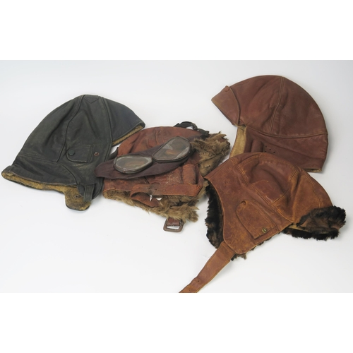 936A - Two mid 1920's  brown leather brown leather flying helmets one with goggles and a German black leath... 