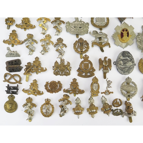 975 - An extensive collection of British army regimental cap badges, including Royal Scots, Royal Artiller... 