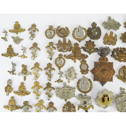 975 - An extensive collection of British army regimental cap badges, including Royal Scots, Royal Artiller... 