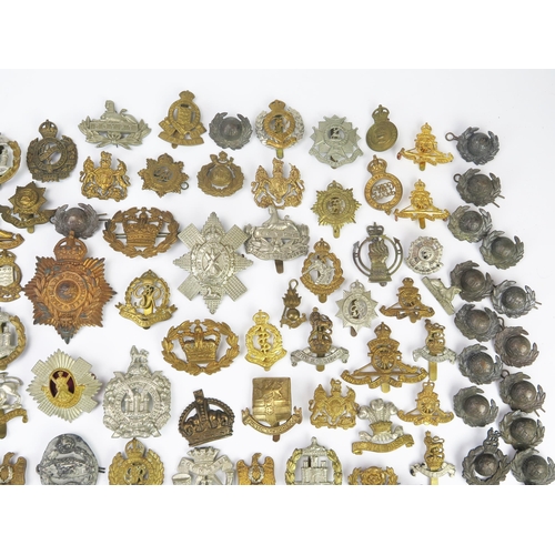 975 - An extensive collection of British army regimental cap badges, including Royal Scots, Royal Artiller... 