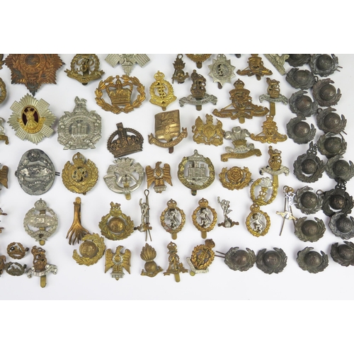 975 - An extensive collection of British army regimental cap badges, including Royal Scots, Royal Artiller... 