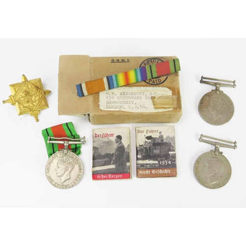 976 - Two World War II War medals, a Defence Medal and two Third Reich propaganda booklets.