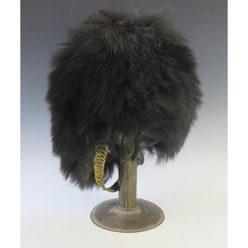 998 - A Grenadier guards bearskin, with white plume, with brass chin strap,