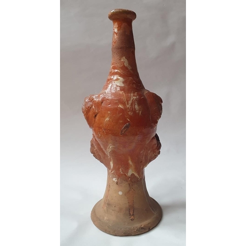 1259 - A late 17th century continental slipware bottle with masque decoration, possibly Italian, 28cm high,