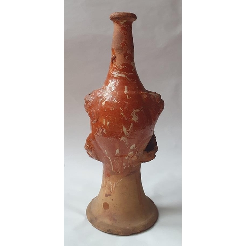 1259 - A late 17th century continental slipware bottle with masque decoration, possibly Italian, 28cm high,