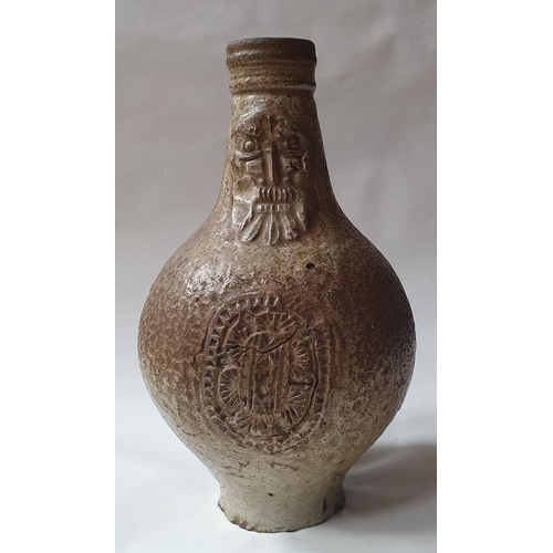 1260 - A 17th century Bellermine bottle, of ovoid form with traditional bearded mask decoration to the neck... 