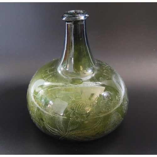 1287 - An early 18th century green glass wine bottle of onion shaped outline with scratched decoration of f...