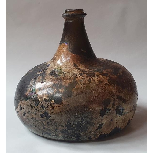 1298 - An 18th century green glass onion-shaped wine bottle, 14cm high. (reputedly unearthed in Devon).