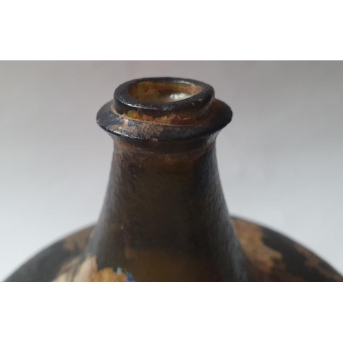 1298 - An 18th century green glass onion-shaped wine bottle, 14cm high. (reputedly unearthed in Devon).