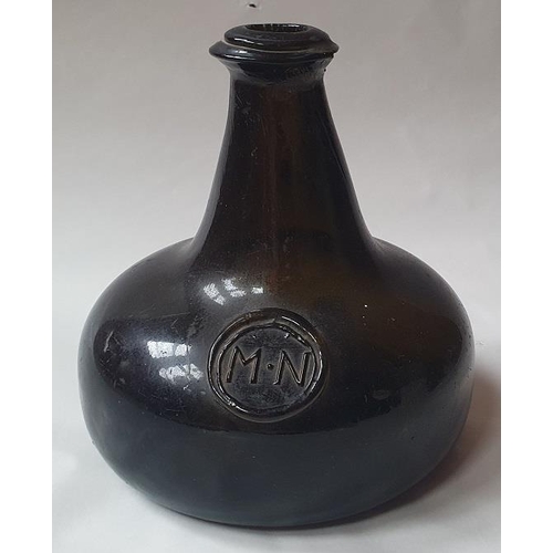 1299 - An 18th century green glass onion-shaped wine bottle, bears seal 'MN', 13cm tall,