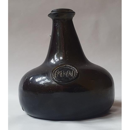 1299 - An 18th century green glass onion-shaped wine bottle, bears seal 'MN', 13cm tall,