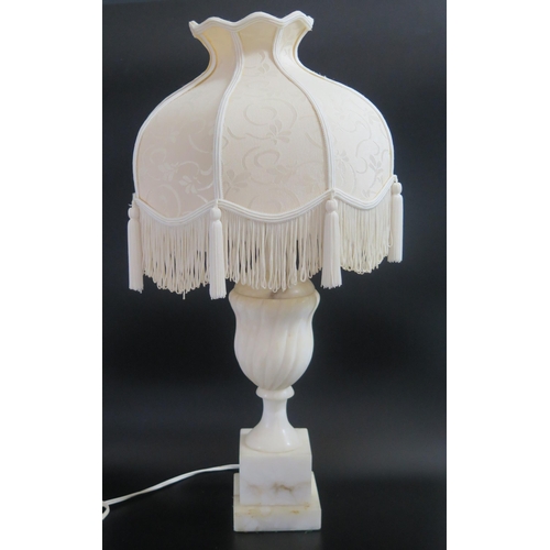 1334A - An Alabaster table lamp, of urn-shaped outline with writhen decoration, raised on a stepped a square... 