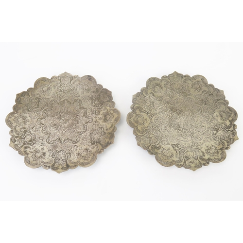 678 - A pair of Indo-Persian silver dishes of circular outline with chased floral decoration, 13cm diamete... 