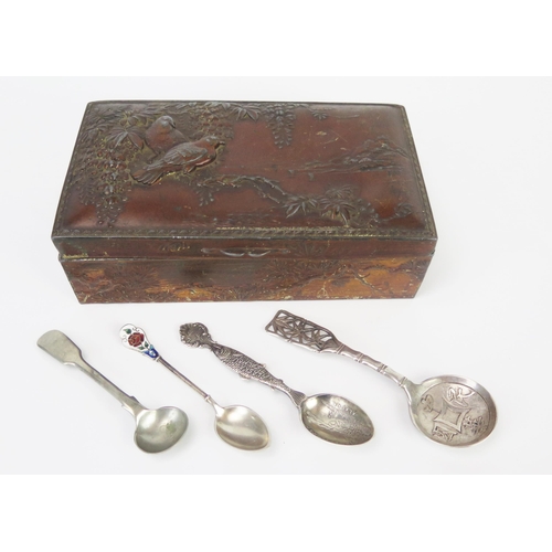 681 - A Japanese antinomy box containing a Chinese silver caddy spoon, and other plated spoons.