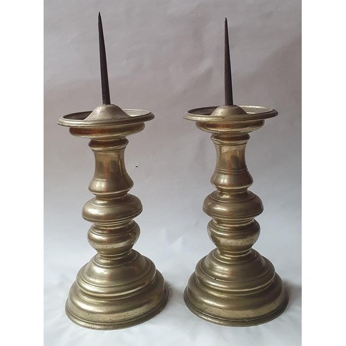 918A - A pair a 19th century pricket candlesticks, with knopped stems and domed circular bases, 36cm high