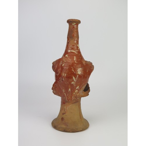 1259 - A late 17th century continental slipware bottle with masque decoration, possibly Italian, 28cm high,