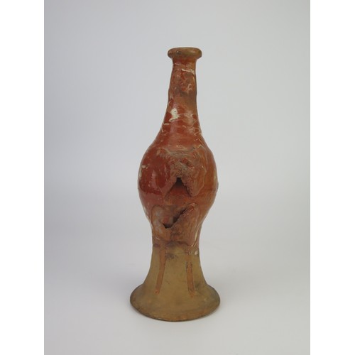 1259 - A late 17th century continental slipware bottle with masque decoration, possibly Italian, 28cm high,