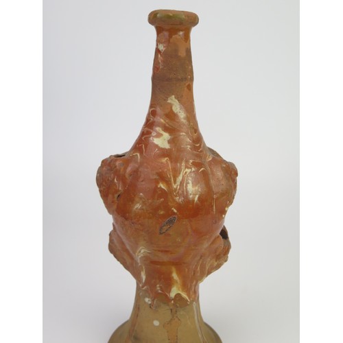 1259 - A late 17th century continental slipware bottle with masque decoration, possibly Italian, 28cm high,