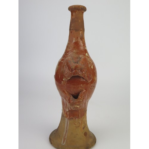 1259 - A late 17th century continental slipware bottle with masque decoration, possibly Italian, 28cm high,