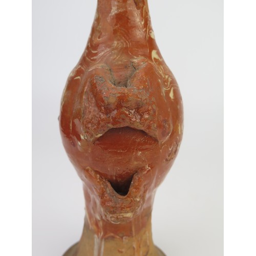 1259 - A late 17th century continental slipware bottle with masque decoration, possibly Italian, 28cm high,