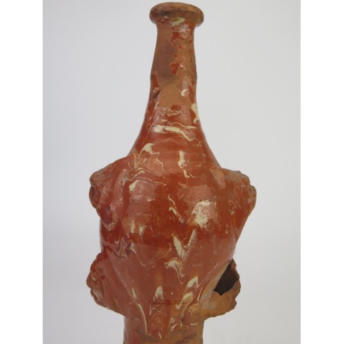 1259 - A late 17th century continental slipware bottle with masque decoration, possibly Italian, 28cm high,