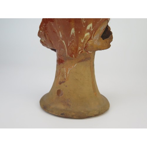 1259 - A late 17th century continental slipware bottle with masque decoration, possibly Italian, 28cm high,