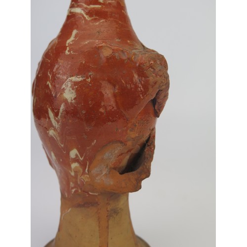 1259 - A late 17th century continental slipware bottle with masque decoration, possibly Italian, 28cm high,