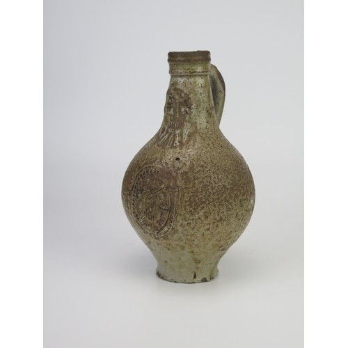 1260 - A 17th century Bellermine bottle, of ovoid form with traditional bearded mask decoration to the neck... 