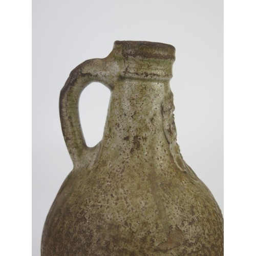 1260 - A 17th century Bellermine bottle, of ovoid form with traditional bearded mask decoration to the neck... 