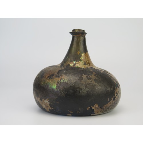 1298 - An 18th century green glass onion-shaped wine bottle, 14cm high. (reputedly unearthed in Devon).