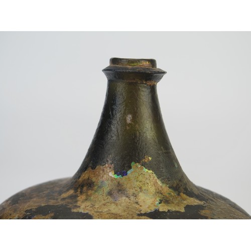 1298 - An 18th century green glass onion-shaped wine bottle, 14cm high. (reputedly unearthed in Devon).