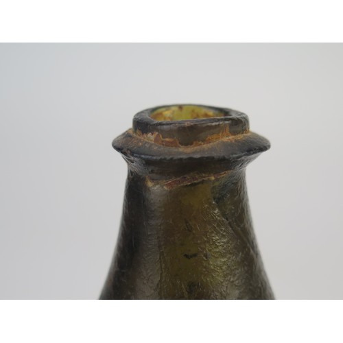 1298 - An 18th century green glass onion-shaped wine bottle, 14cm high. (reputedly unearthed in Devon).