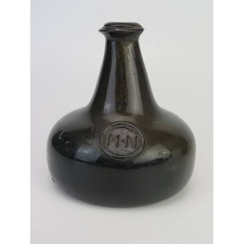 1299 - An 18th century green glass onion-shaped wine bottle, bears seal 'MN', 13cm tall,