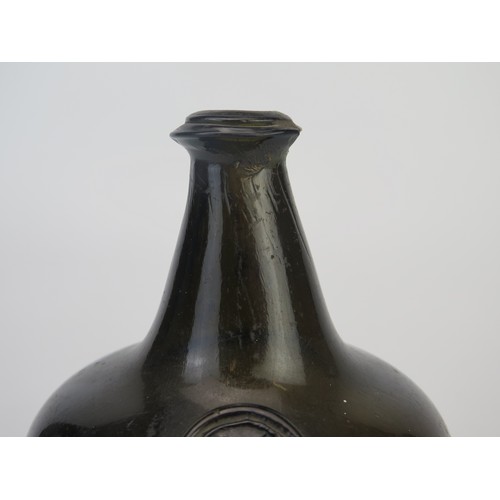 1299 - An 18th century green glass onion-shaped wine bottle, bears seal 'MN', 13cm tall,