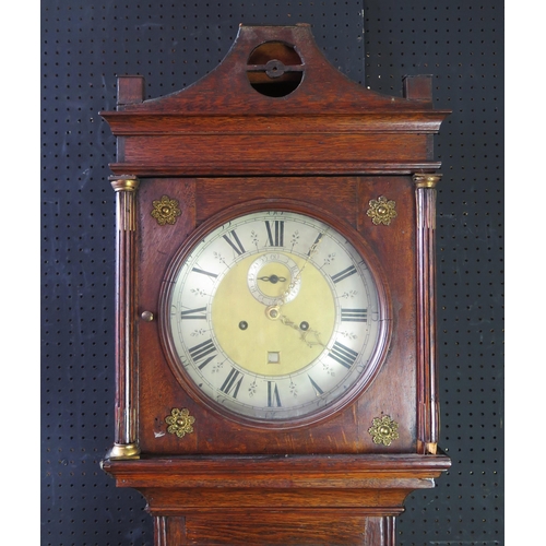 1314 - An early 19th century oak longcase clock, the arched hood with fluted columns, the trunk having a  p... 