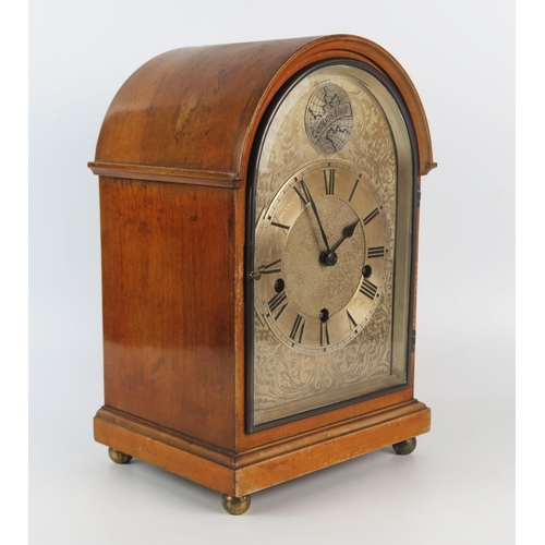 1316 - A mahogany mantel clock of arched outline with silvered arched Roman dial, the HALLER triple train m... 