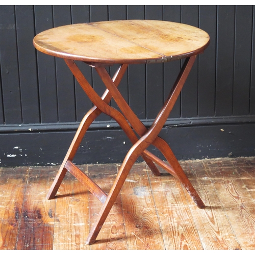 1328 - An early 19th century mahogany and brass folding coaching table, the circular hinged top raised on X... 