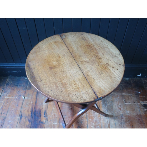 1328 - An early 19th century mahogany and brass folding coaching table, the circular hinged top raised on X... 