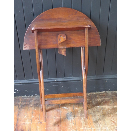 1328 - An early 19th century mahogany and brass folding coaching table, the circular hinged top raised on X... 