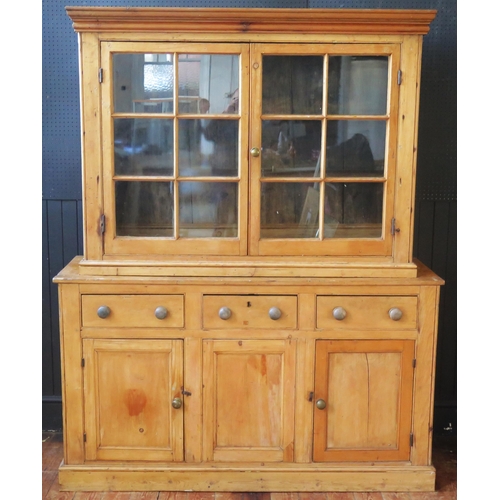 1337 - A 19th century pine dresser, the associated top with moulded cornice, above a pair of glazed panel d... 