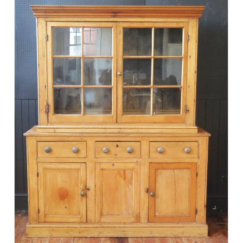 1337 - A 19th century pine dresser, the associated top with moulded cornice, above a pair of glazed panel d... 