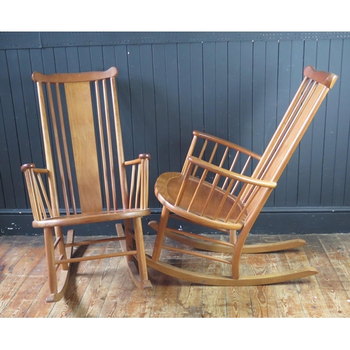 1340 - A pair of teak rocking chairs with solid central splat and spindle back with solid seat on rocker su... 