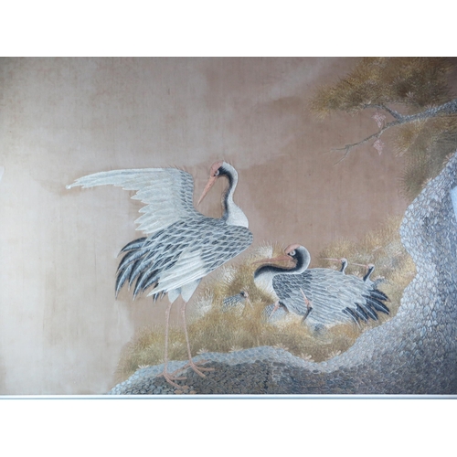 1384 - A large Japanese silk picture of a pair of cranes and their young, worked in coloured silks, F & G 7... 