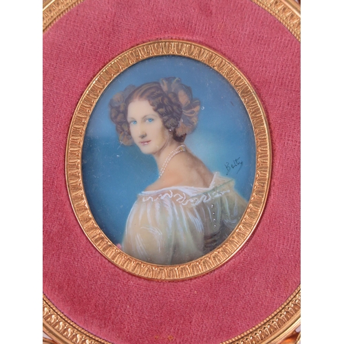 1386 - An oval miniature portrait of a young woman, in lace dress, oil on celluloid, signed Betty, containe... 